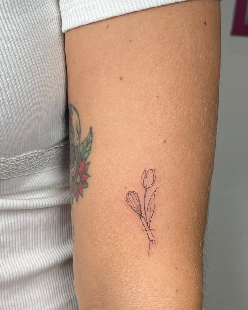 Tulipán minimalista en línea fina en el brazo